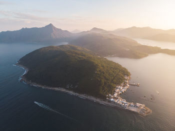 High angle view of sea and mountains against sky