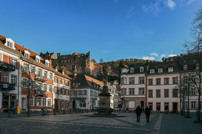 Buildings in city against blue sky