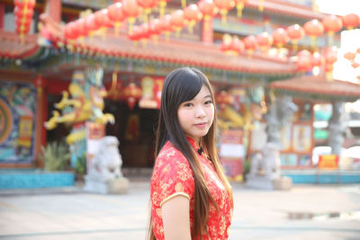 Portrait of young woman standing in store