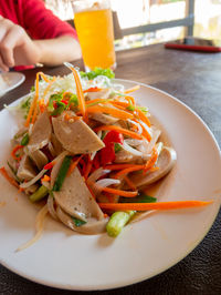 Close-up of person preparing food in plate