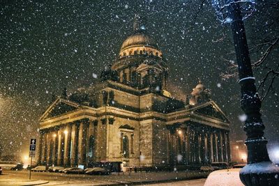Illuminated church during winter at night