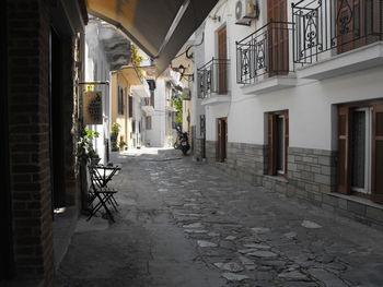 Empty alley amidst buildings in city