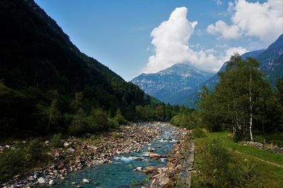 Scenic view of land and mountains against sky