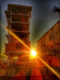 Low angle view of building against sky at sunset