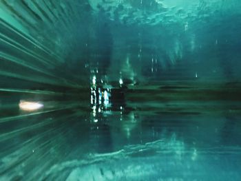 Reflection of illuminated swimming in sea