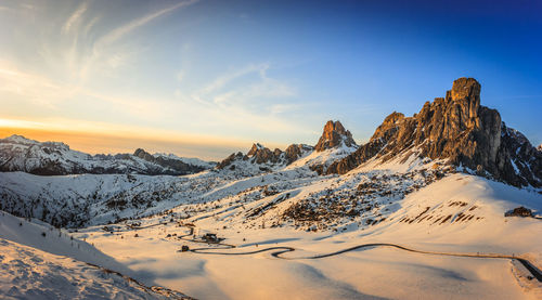 Scenic view of snowcapped mountains against sky during sunset