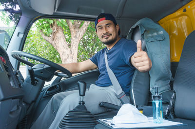 Young man sitting in car