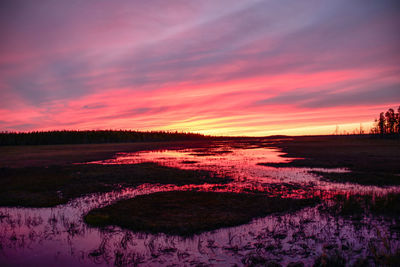 Scenic view of lake against romantic sky at sunset