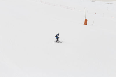 Person skiing on snow covered field