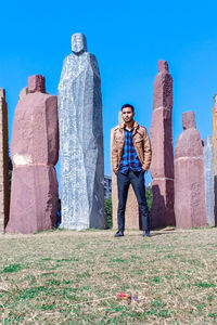 Man standing on field against clear sky