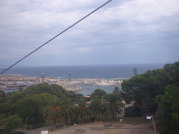 Scenic view of sea by city against sky
