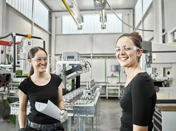 Two woman working on a machine