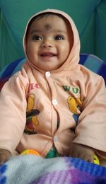 Portrait of cute baby girl on bed