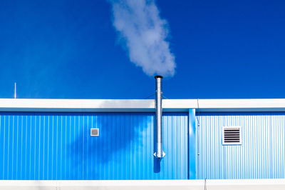 Smoke stack against blue sky