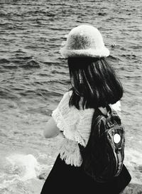 Close-up of man with umbrella in sea