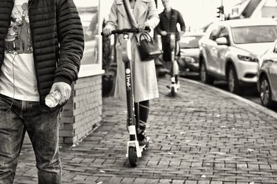 Rear view of people standing on street