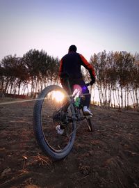 Man riding bicycle on field