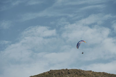 Skydiver flying in blue sky in sunny day