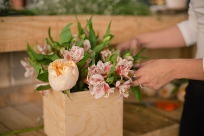 Close-up of hand holding rose bouquet