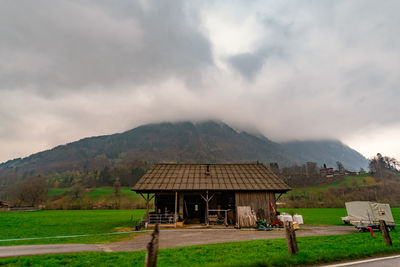 Built structure on field against sky