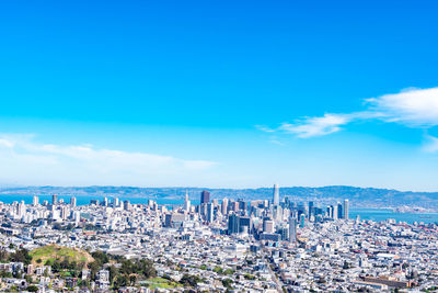 High angle view of buildings against blue sky