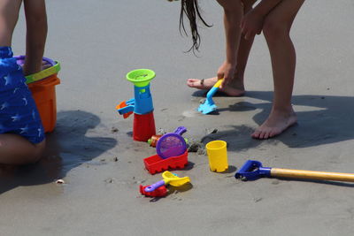 Low section of women playing with toy on beach