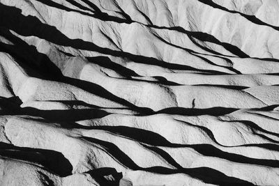 Shadow of a person walking on the layers of rock and shadows