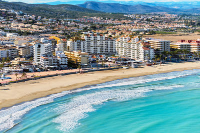 High angle view of buildings by sea during sunny day