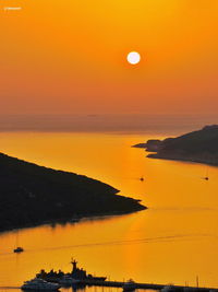 Scenic view of sea against orange sky