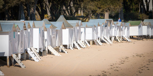 Row of chairs on sand at beach