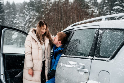 Rear view of mother and son in car