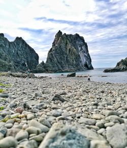 Rocks on beach against sky