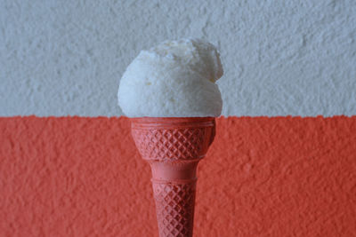 White and red colored  ice cream cone on a sunny day