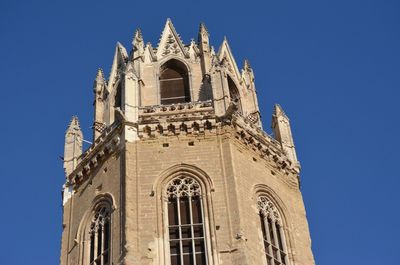 Low angle view of historic building against clear blue sky