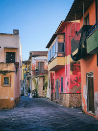 Street amidst buildings in town against sky