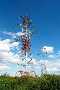 Low angle view of electricity pylon against sky