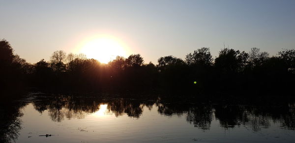 Scenic view of lake against sky during sunset