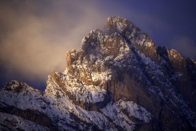 Low angle view of snowcapped mountain against sky