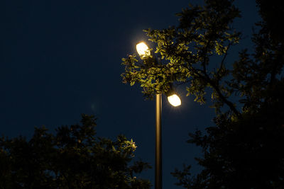 Low angle view of illuminated street light against sky at night
