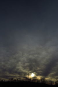 Low angle view of storm clouds over landscape