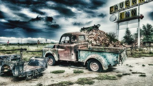 Abandoned car against sky