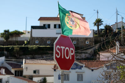 Close-up of road sign against buildings in city