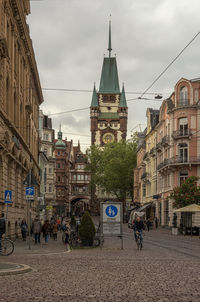 Unidentified people in front of the medieval martins gate, freiburg, germany