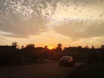 Cars on road at sunset