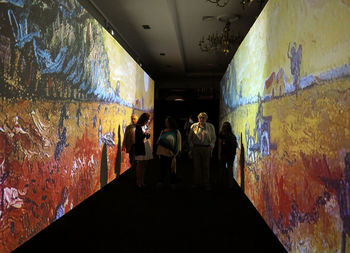 Rear view of people standing in tunnel