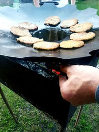 High angle view of person preparing food on barbecue grill