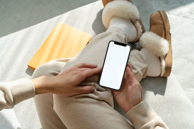 Midsection of woman using mobile phone