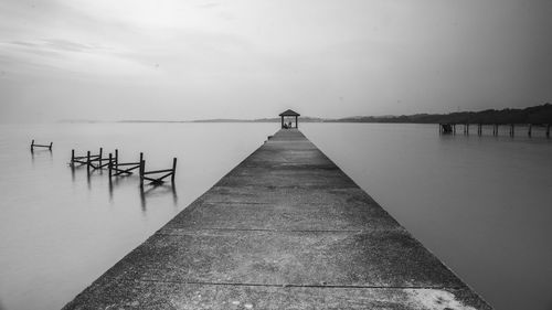 Pier over sea against sky