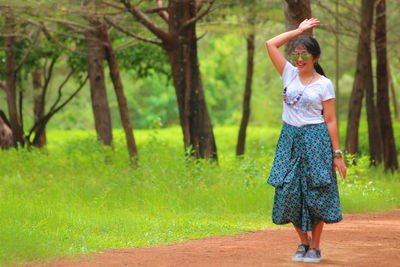 Full length of woman standing on road