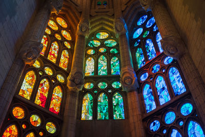 Low angle view of designed stained glass windows at sagrada familia